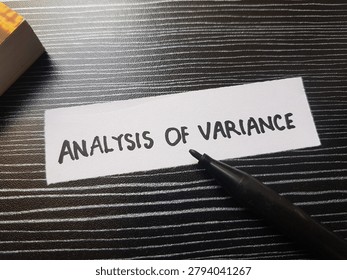 The writting analysis of variance on table background. 
