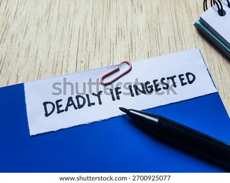 The writting deadly if ingested on table background.