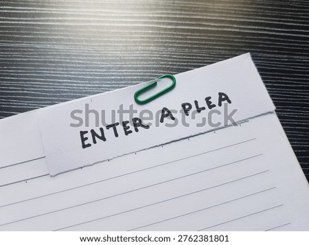The writting enter a plea on table background. 