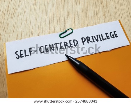 The writting self - centered privilege on table background.