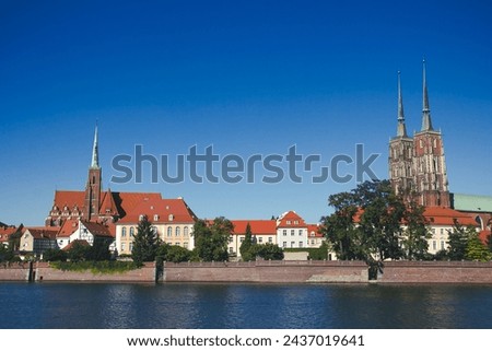 Wroclaw city in Poland. Polish urban cityscape. Odra river flowing through the city scenter. Old town tower. Breslau famous scenery.