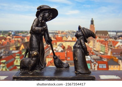Wroclaw gnomes. Witches Tekla and Martynka (aka Czarownice Tekla i Martynka) on the Penitents Bridge (aka Mostek Pokutnic) between towers of St. Mary Magdalene's Church