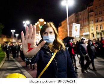 Wroclaw, Poland, 28 October 2020 - Polish Woman has drawn a sign "Women's Strike" on her hand on background with crowd of protesting people. Protest against tightening of the abortion law in Poland. 