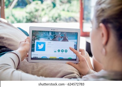 WROCLAW, POLAND- APRIL 10th, 2017:  Woman is installing Twitter application on Lenovo tablet. Twitter  is an online news and social networking service where users post and interact with messages