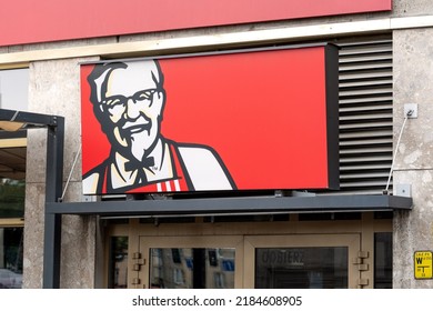 Wroclaw, Poland - April 2022: KFC Kentucky Fried Chicken fast food restaurant chain signage logo closeup, Colonel Sanders, building entrance brand symbol detail up close, nobody, no people, no text