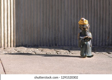 WROCLAW, POLAND, AUGUST 2018: The Gnome Of Wroclaw, Profesor Dwarf, Standing In Front Of University.