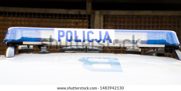 Wroclaw, Poland - August 8 2019:\
Close-up of police logo on police car (Policja means\
Police)