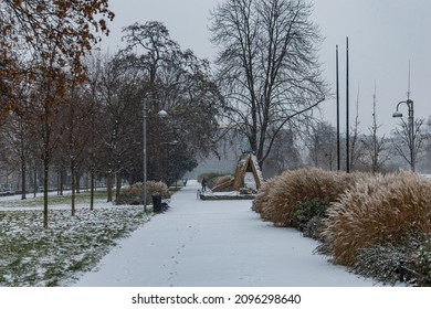 Wroclaw, Poland - December 3 2020: Snowy Alley In Park Next To Promenade Full Of Trees And Bushes