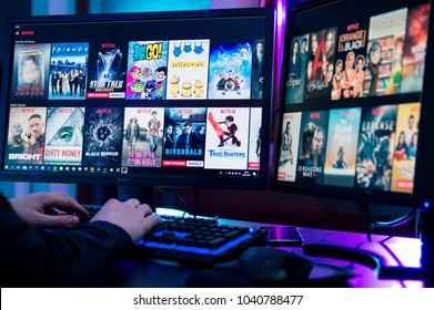 WROCLAW, POLAND -  FEBRUARY 02th, 2018: Man reviews the movie offer in netflix. Netflix is an American entertainment company specializes in and provides streaming media
