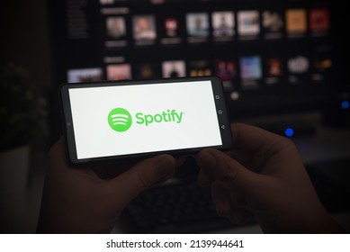 Wroclaw, Poland - JAN 27, 2022: Man With Spotify Logo On Screen. Spotify Is Most Popular Music Streaming Platform.