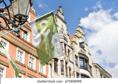 WROCLAW, POLAND - JULY 4th, 2017. The World Games Wroclaw 2017 Flags Waving On The Background Of Wroclaw's Town Houses.