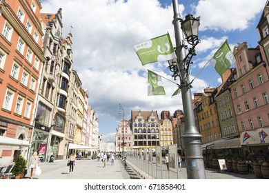 WROCLAW, POLAND - JULY 4th, 2017. The World Games Wroclaw 2017 Flags Waving On The Background Of Wroclaw's Town Houses.