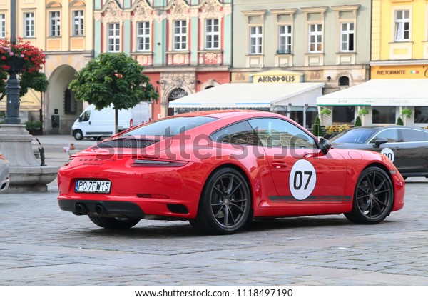 WROCLAW, POLAND - June 11, 2018:\
Porsche 70th Anniversary. Sport Car Together Day. Red Porsche 911\
Carrera T exposed on Rynek (Market) Square in\
Wroclaw.