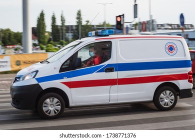 WROCLAW, POLAND - MAY 22, 2020. Ambulance On The Street. Due To Coronavirus Pandemic Driver Has Face Mask.