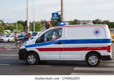 WROCLAW, POLAND - MAY 22, 2020. Ambulance On The Street. Due To Coronavirus Pandemic Driver Has Face Mask.