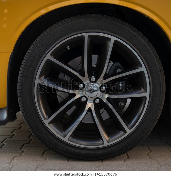 Wroclaw, Poland - May 31, 2019:\
Wheel and tire of modern american muscle car Dodge Challenger.\
Dodge is the brand owned by FCA US LLC. Alloy wheel with Brembo\
brakes.