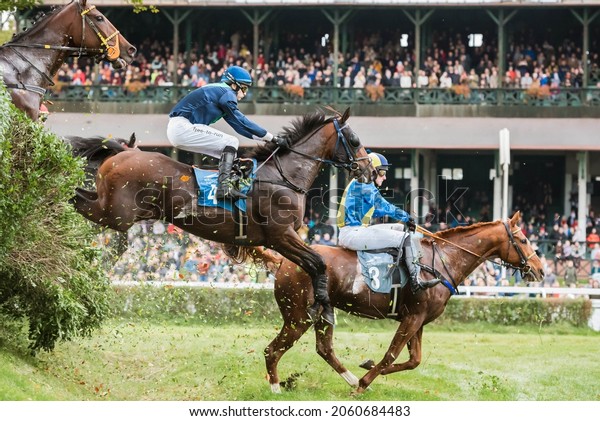 WROCLAW, POLAND - OCTOBER 16; 2021: Steeplechase race\
Crystal Cup for five years old horses and older at Racecourse WTWK\
Partynice. Jockey C. Roberts on horse Haad Rin (4) and J. Myska on\
Larizano (5)
