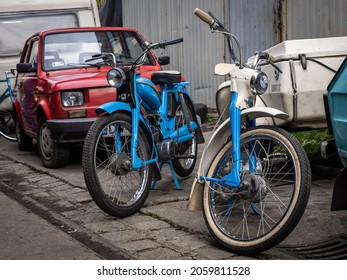 Wroclaw, Poland - September 19, 2021:
Two vintage blue Komar motorcycles and a red 126 Fiat car. 
