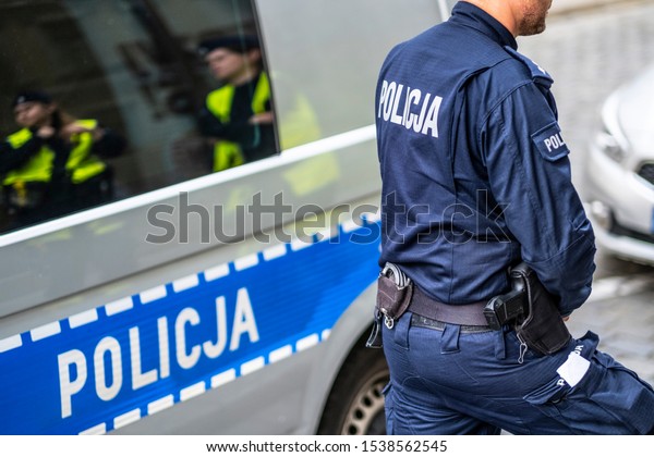 Wroclaw, Poland-ocobert/19/2019 The\
policeman on the street on duty. Close up of police\
logo.