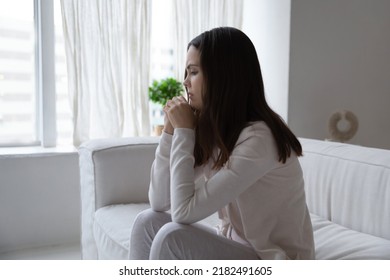 Wrong day. Crying distressed young female sitting on couch in living room meeting morning with tears being abandoned jilted after heartbreak divorce, running into debts, feeling desperate hopeless - Shutterstock ID 2182491605