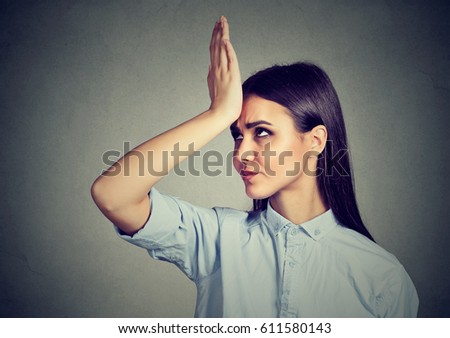 Wrong doing. Closeup portrait upset woman, slapping hand on head having duh moment isolated on gray background. Negative human emotion feeling, body language