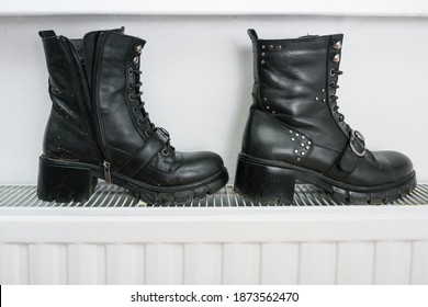 Wrong Drying Of Footwear, A Pair Of Dirty Leather Winter Shoes On A Hot Central Heating Radiator.