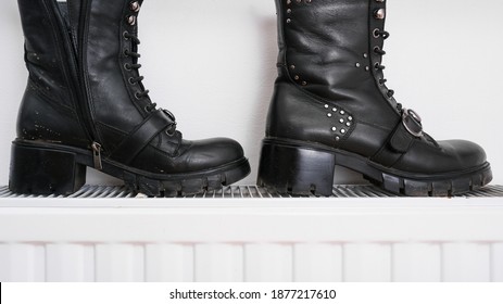 Wrong Drying Of Footwear, A Pair Of Dirty Leather Winter Shoes On A Hot Central Heating Radiator.