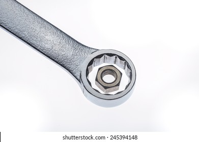 Wrong sized wrench for hex nut mismatch on white background 