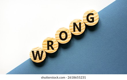 Wrong symbol. Concept word Wrong on beautiful wooden circles. Beautiful white and blue background. Business lifestyle wrong concept. Copy space.