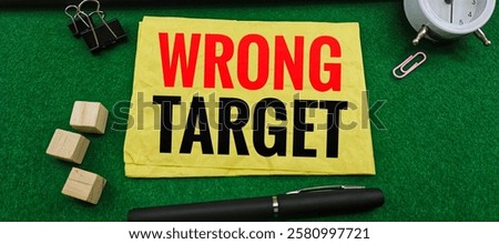 Wrong Target on Paper with Black Pen, Wooden Blocks, Paperclip, and White Alarm Clock on Desk: Exploring Misguided Goals and Missteps in Strategy. 