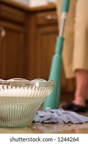 Wrong Tool For The Job: Young Woman Using A Crystal Punch Bowl As A Mop Bucket.