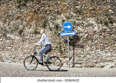 Wrong Way. Businessman Going On Bicycle The Wrong Direction