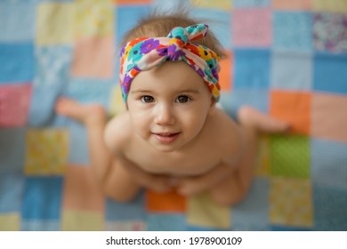 Wrong ways sitting position for child. The child is sitting in the frog pose. Hallux valgus. The wrong position when sitting at the girl. W-pose. W-sitting. children's orthopedics. cute baby