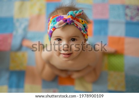 Wrong ways sitting position for child. The child is sitting in the frog pose. Hallux valgus. The wrong position when sitting at the girl. W-pose. W-sitting. children's orthopedics. cute baby