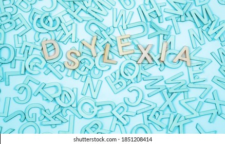 Wrongly Spelt Dyslexic Word Concept Background -  Jumbled  Alphabet Letters In Turquoise Blue  With The Word Dyslexia Spelt Wrong On Top And Space For Message 
