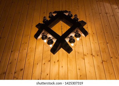 Wrought Iron Chandelier On A Wooden Ceiling