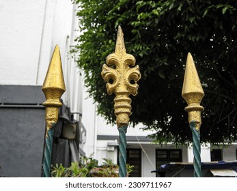 Wrought iron fence with decorative arrow and spear ornament in Stasiun Kota train station, West Jakarta

