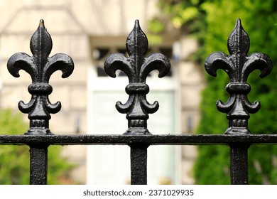 Wrought iron fence finials Heraldic lily shape. Heraldic lily wrought iron fence decorations. Wrought iron fence ornamental lilies. Iron fence flower-shaped toppers