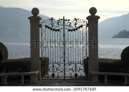 Wrought iron gate in a park in Lugano as an entrance from the lake. 