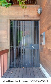 Wrought iron gate with wood planks walls and pathway at San Francisco, California