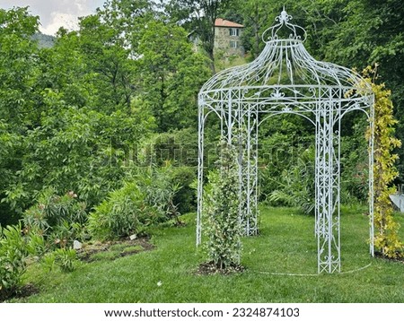wrought iron gazebo in a splendid English garden of a restaurant on the Ligurian Riviera of Varazze in the summer of 2023