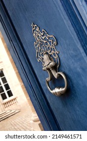 Wrought iron knocker and blue wooden door