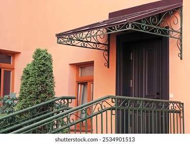 Wrought iron railing on porch stairs and awning private home.  - Powered by Shutterstock