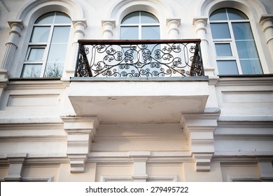 Wrought-iron balcon on the light side of the building. Toned.