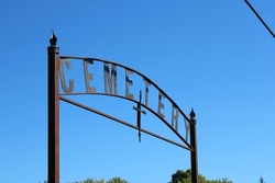 A Wrought-iron Cemetery Sign At The Entrance To An Old Abandoned Cemetery