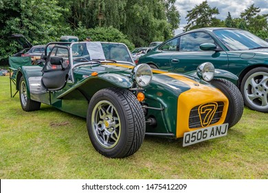 Wroxham, Norfolk, UK – July 21 2019. Side on view of a classic Lotus 7 kit car in British racing green and yellow on display at the annual classic car show in Wroxham, Norfolk, UK