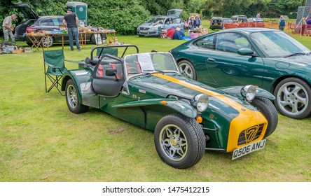 Wroxham, Norfolk, UK – July 21 2019. Side on view of a classic Lotus 7 kit car in British racing green and yellow on display at the annual classic car show in Wroxham, Norfolk, UK