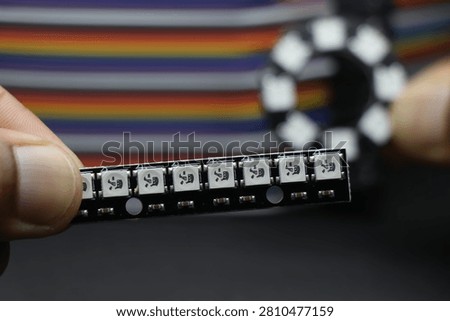 ws2812b led strip module for diy electronics projects with round board LED in the background