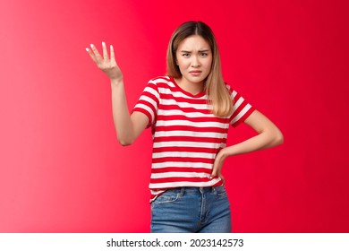 Wtf nonsense. Pissed unsatisfied female customer complain unaccepatable behaviour raise hand dismay frowning arguing, look questioned disappointed, annoyed strange situation, red background