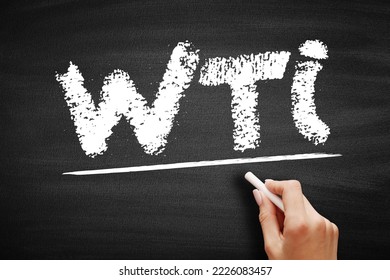 WTI West Texas Intermediate - light, sweet crude oil that serves as one of the main global oil benchmarks, acronym text on blackboard - Shutterstock ID 2226083457